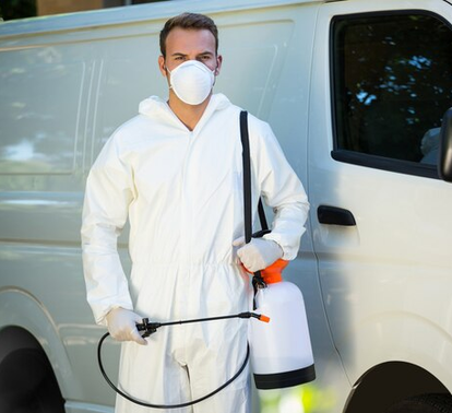 Pest control technician standing next to service vehicle – Angel City Pests